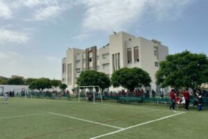 Abbasiyeh main campus Stars College main campus facade with students gathered in the playground