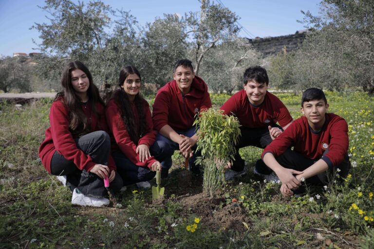 Grade 10 Stars College students planting a tree during sustainability project in Harsh Al-Abbasiyeh